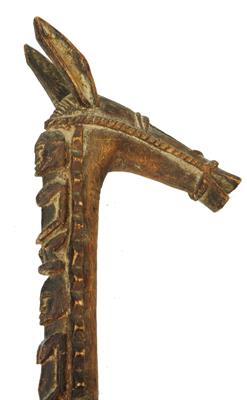 Lot 375 - AN AFRICAN CARVED WOODEN STAFF HANDLE in the form of a long earred ass wearing harness