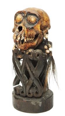 Lot 387 - A NEW GUINEA KORWAR ANCESTOR FIGURE in the form of a monkey skull with inset shell eyes and carved