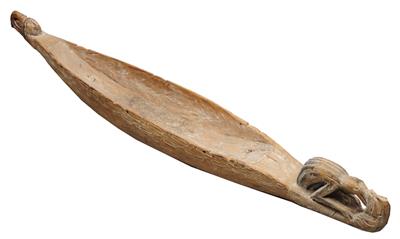 Lot 389 - A PAPUA NEW GUINEA CARVED WOOD CANNIBAL FEAST BOWL in the form of a canoe with shaped prow and