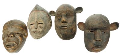 Lot 450 - A GROUP OF FOUR AFRICAN CARVED WOOD TRIBAL MASKS