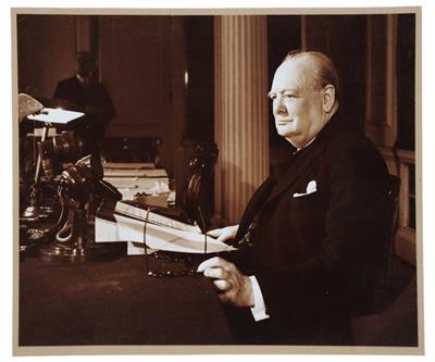 Lot 671 - A PHOTOGRAPHIC PORTRAIT of Sir Winston Churchill seated at his desk