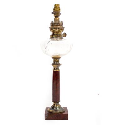 Lot 482 - A RED MARBLE BASED OIL LAMP