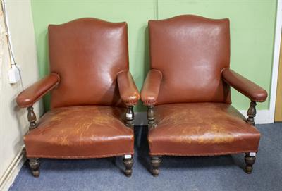 Lot 513 - A PAIR OF OAK FRAMED BROWN LEATHER UPHOLSTERED ARM CHAIRS