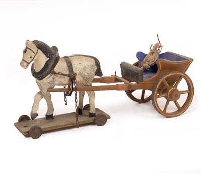 Lot 251 - AN EARLY 20TH CENTURY CARVED PAINTED WOODEN TOY HORSE AND WAGON