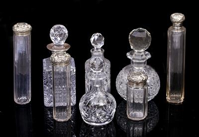 Lot 422 - FOUR GLASS BOTTLES AND A CUT GLASS ATOMIZER