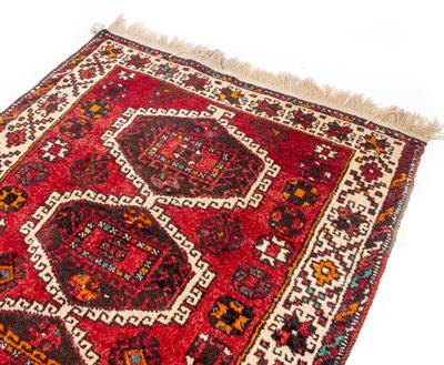 Lot 596 - AN ORIENTAL RED GROUND RUG