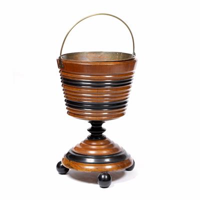 Lot 2 - A 19TH CENTURY DUTCH WALNUT AND EBONISED ICE BUCKET with brass swing handle having turned tapering