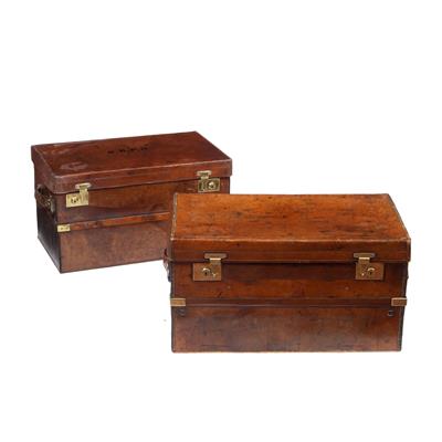 Lot 33 - TWO GRADUATED LATE 19TH/EARLY 20TH CENTURY BRASS BOUND LEATHER TRAVELLING TRUNKS with side carrying