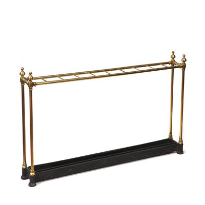 Lot 74 - A VICTORIAN BRASS TEN SECTION STICK STAND with turned finials and black painted metal drip tray base