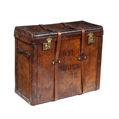 Lot 145 - A 19TH CENTURY LEATHER LARGE TRUNK with brass locks and strap fastenings