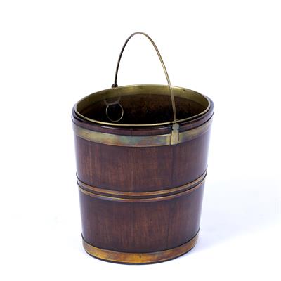 Lot 280 - A GEORGE III MAHOGANY AND BRASS BOUND OVAL PEAT BUCKET with swing handle and brass liner