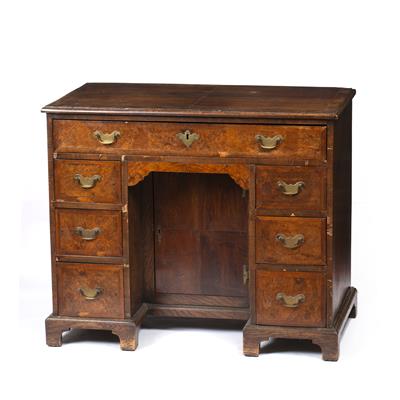 Lot 292 - A QUEEN ANNE STYLE FIGURED WALNUT AND MAHOGANY VENEERED KNEEHOLE DESK with an arrangement of seven