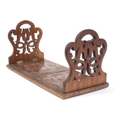 Lot 299 - A LATE VICTORIAN WALNUT FOLDING BOOKSTAND with shaped and pierce decorated ends