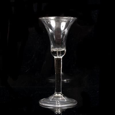 Lot 315 - AN 18TH CENTURY WINE GLASS with bell flared bowl incorporating an air bubble to a plain stem and