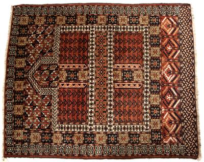 Lot 336 - A TURKOMAN HATCHLI WINE RED GROUND RUG with geometric panels and hooked border