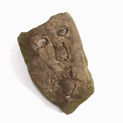 Lot 366 - A ROUGH HEWN STONE CORBEL with carved image of a human face