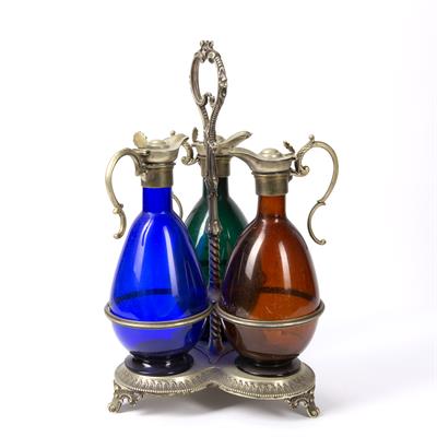 Lot 265 - Set of three coloured glass claret jugs