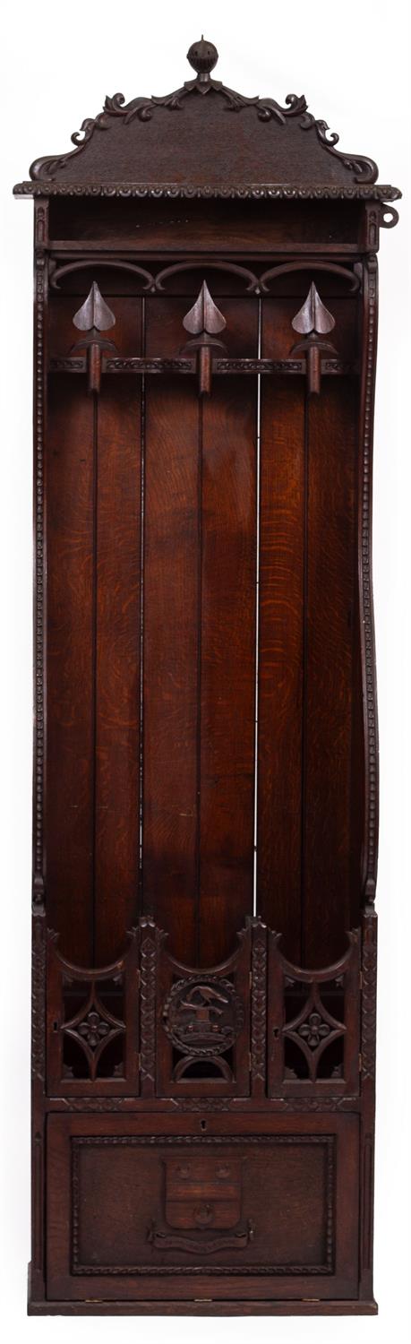 Lot 105 - A 19TH CENTURY CARVED OAK GUN CABINET