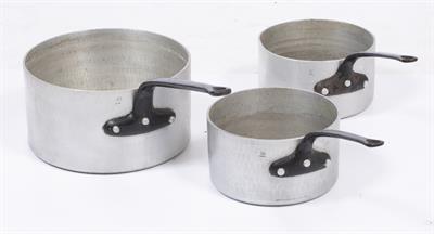 Lot 187 - A SET OF THREE FRENCH ALUMINIUM AND IRON LARGE SAUCEPANS