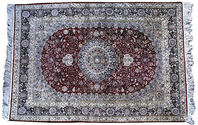 Lot 220 - AN ORIENTAL SILK RED GROUND RUG