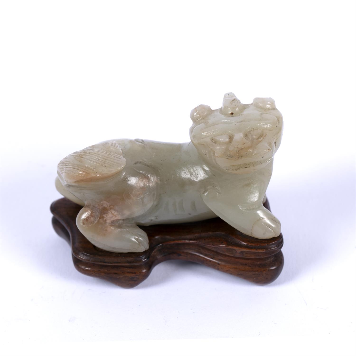 Lot 219 - Mutton fat jade carving of a Buddhistic lion