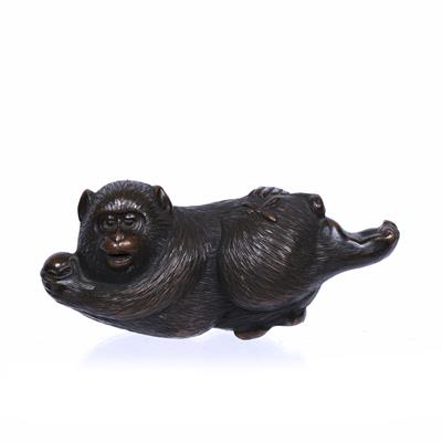 Lot 751 - Bronze model of a reclining monkey