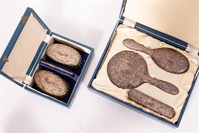 Lot 48 - A CASED SILVER BACKED DRESSING TABLE SET