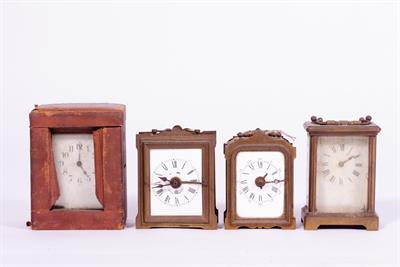 Lot 58 - A GROUP OF FOUR MECHANICAL CARRIAGE TYPE CLOCKS