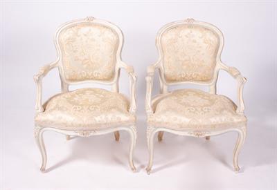 Lot 99 - A PAIR OF FRENCH CREAM PAINTED OPEN ARMCHAIRS