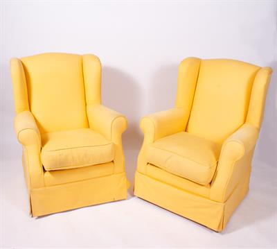 Lot 102 - A PAIR OF YELLOW UPHOLSTERED WING BACK ARMCHAIRS