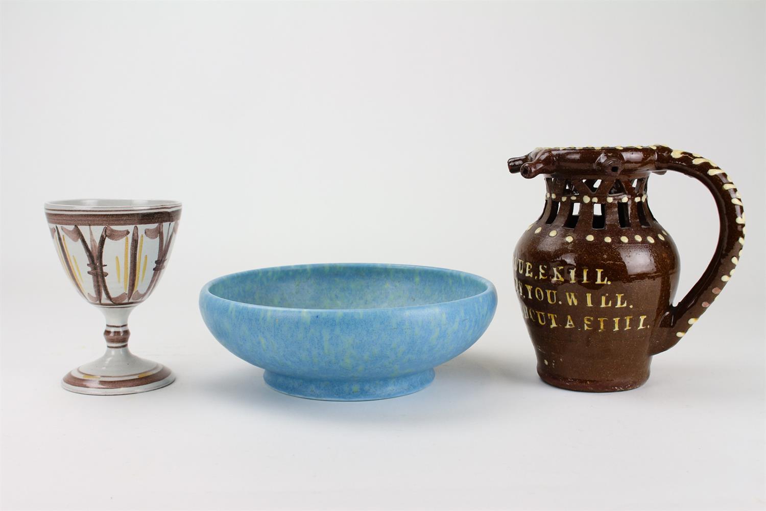 Lot 136 - A SLIPWARE PUZZLE JUG