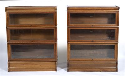 Lot 194 - A NEAR PAIR OF OAK GLOBE WERNICKE STYLE THREE TIER GLAZED BOOKCASES