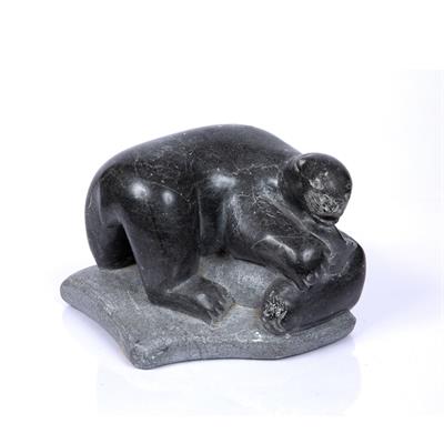 Lot 11 - A CANADIAN INUIT ART CARVED GREYSTONE FIGURE GROUP of a polar bear with seal prey