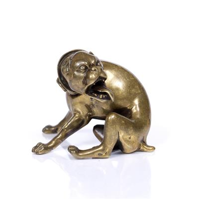 Lot 49 - A BRONZE MODEL OF A SEATED HUNTING HOUND turning in a snarling expression with wide collar