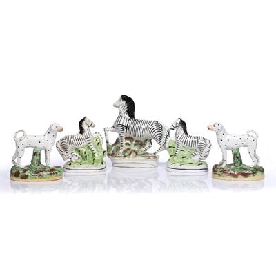 Lot 100 - A PAIR OF 19TH CENTURY STAFFORDSHIRE FIGURES  of dalmations