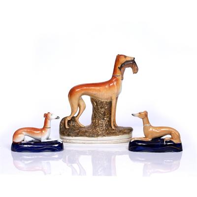 Lot 101 - A 19TH CENTURY STAFFORDSHIRE FIGURE  of a greyhound with rabbit in his jaws