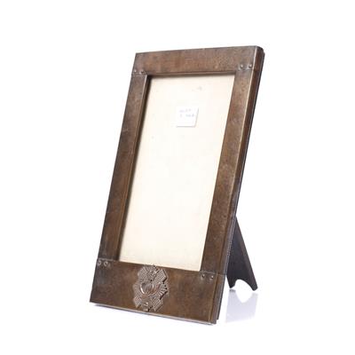 Lot 111 - AN ARTS & CRAFTS BEATEN COPPER RECTANGULAR PHOTOGRAPH FRAME bearing the badge for the 74th Highland