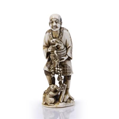 Lot 117 - A JAPANESE IVORY OKIMONO of a standing figure holding a rabbit in a wicker basket with a further