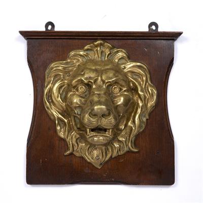 Lot 128 - A BRONZE LION MASK mounted on an oak wall plaque