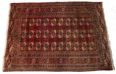 Lot 206 - A TEKKE BOKHARA TRIBAL RUG with three rows of ten medallions on a deep red ground and within a