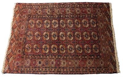Lot 207 - A TEKKE BOKHARA MID RED GROUND TRIBAL RUG decorated three rows of nine elephant foot medallions