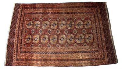 Lot 208 - A TEKKE BOKHARA RED GROUND TRIBAL RUG decorated two rows of eight elephant foot medallions with a