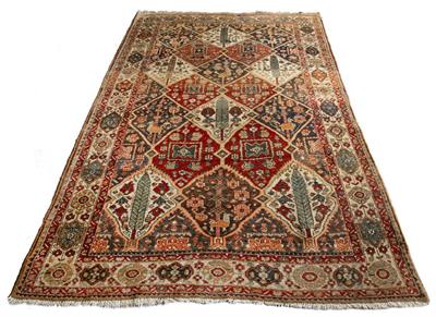 Lot 213 - AN EASTERN PERSIAN PATTERN CARPET with stylised conifer medallions with a diamond patterned field