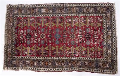 Lot 216 - AN OLD PERSIAN RED GROUND RUG with a polychrome complex design of geometric patterns and scrolls