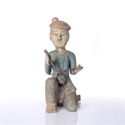 Lot 239 - AN OLD FAR EASTERN CARVED AND POLYCHROME DECORATED FIGURE of a seated musician playing a stringed