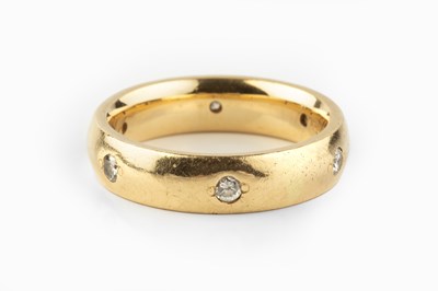 Lot 138 - A diamond set band ring, the court section...