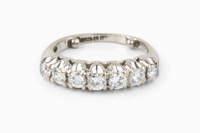 Lot 121 - A diamond half hoop ring, the uniform round...