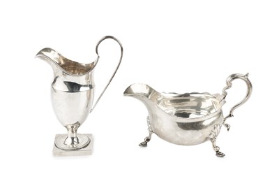 Lot 397 - A George V silver sauce boat, with scroll...