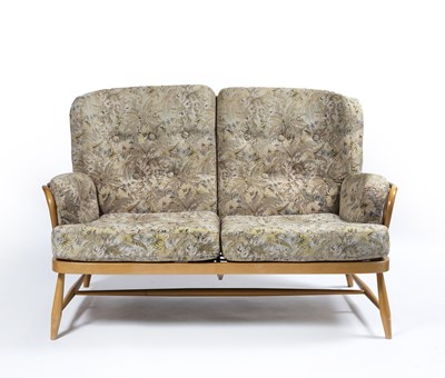 Lot 51 - Ercol light elm sofa, with floral upholstered...