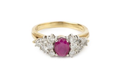 Lot 64 - A ruby and diamond cluster ring, the oval...